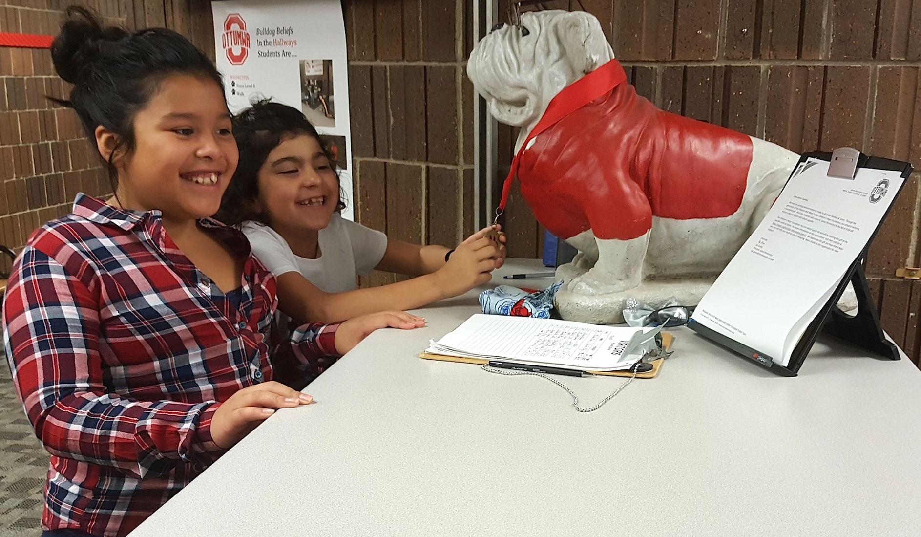 Jayden Nunez, 10 & Maggie Nunez, 8, prepare to register at James school